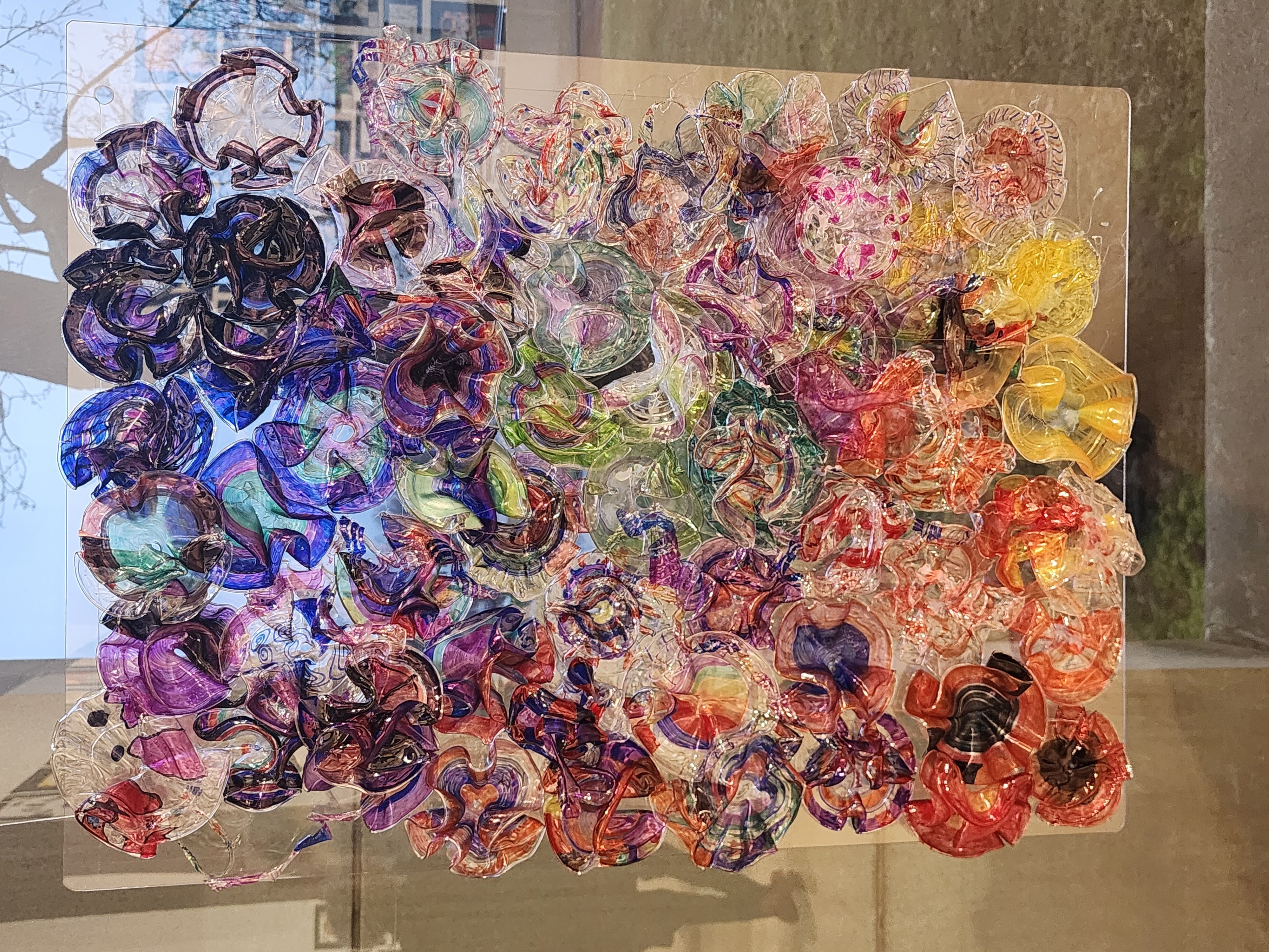 A colorful glass-like piece of art on display at the gallery